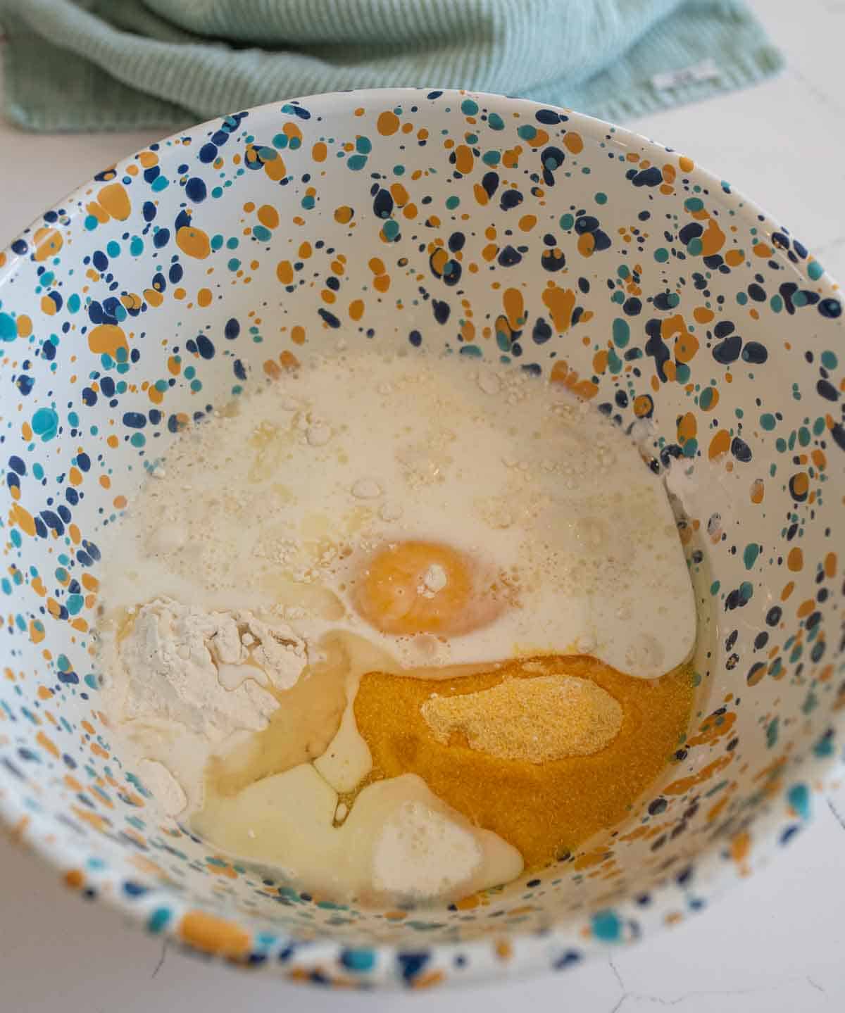 wet and dry ingredients in cornbread in bowl.