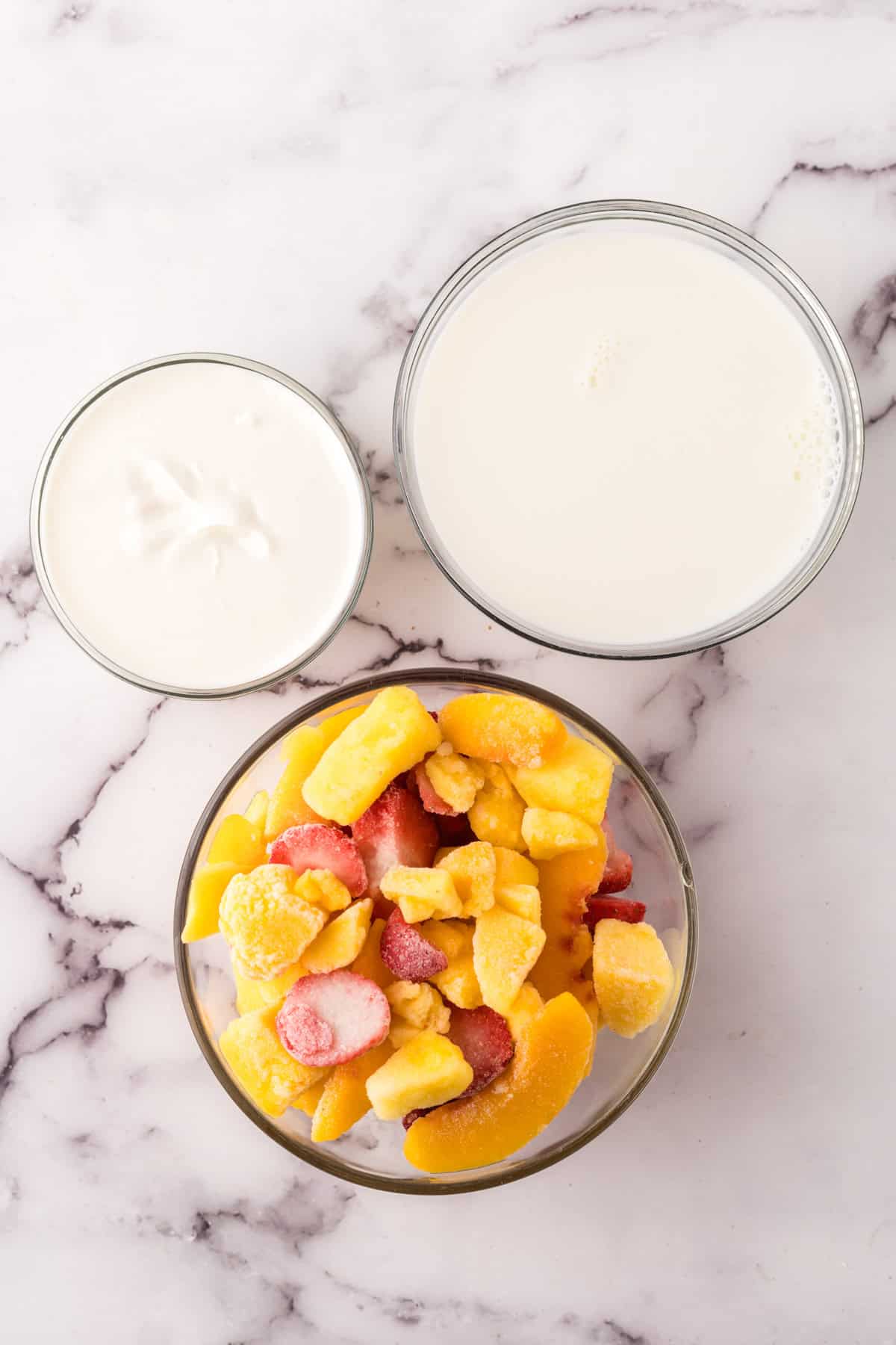 portion bowls each with raw ingredients to make good, better, best smoothie recipe.