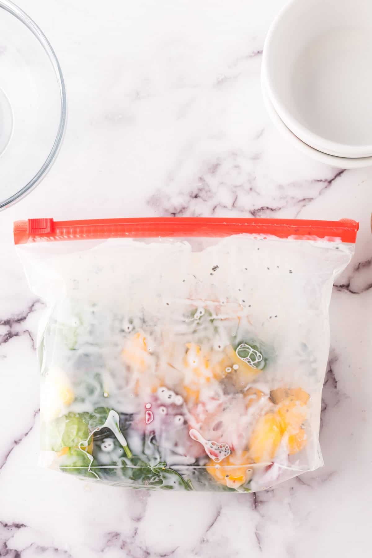 Prepared frozen smoothie bag enclosed on a counter.